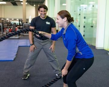 trainer and someone working out