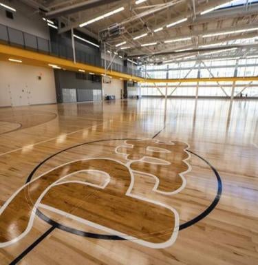 A backetball court with the Pitt script.